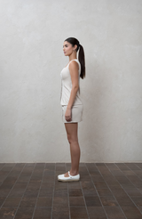 Greige mini skirt with fabric buttons and piping