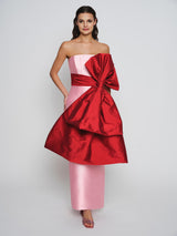 Pink mikado dress with exaggerated red bow